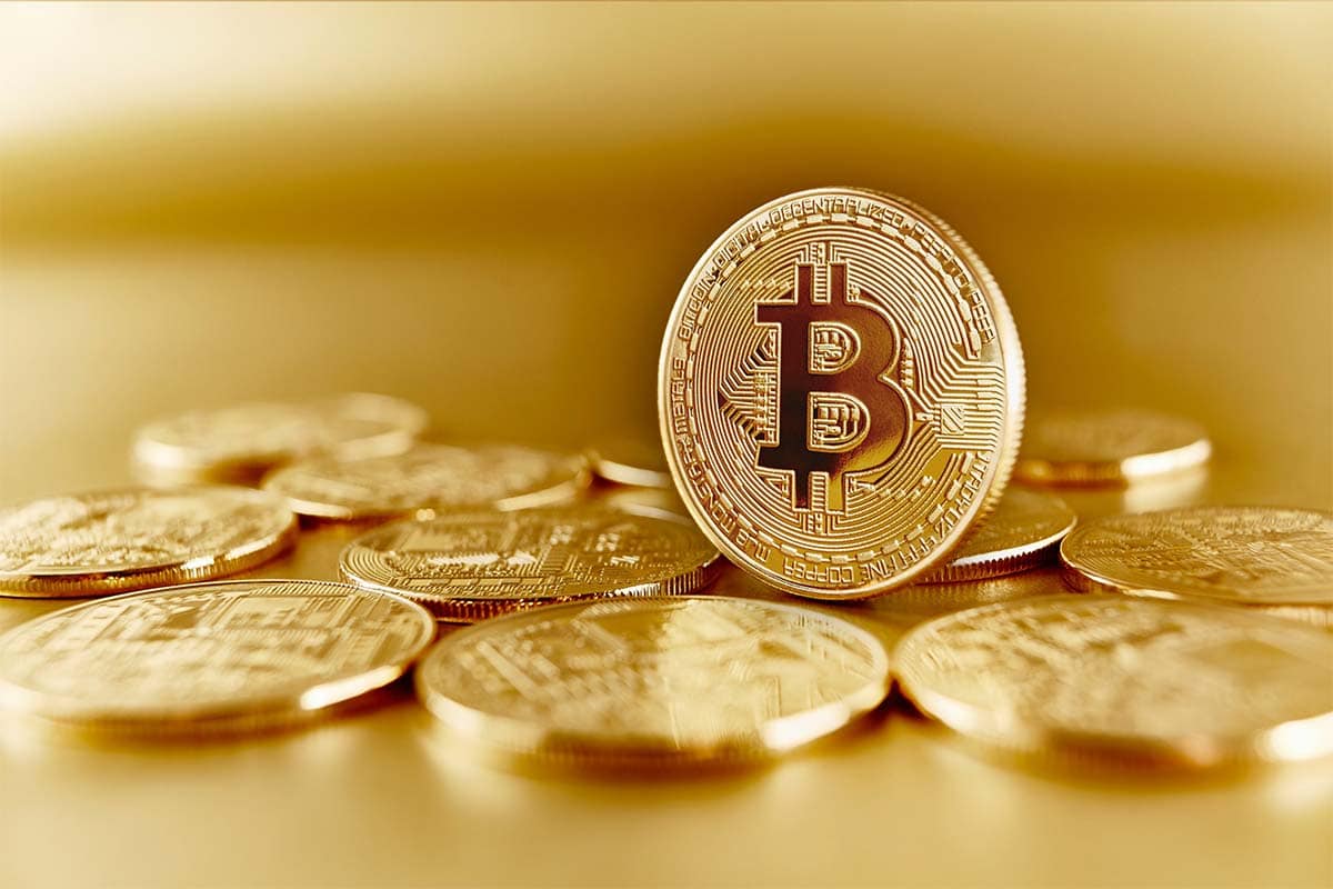 Gold Bitcoins on a table. What Is Cryptocurrency? Mydollarbills