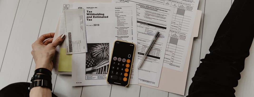A person is filling a tax form.